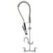 A Fisher stainless steel wall mounted pre-rinse faucet with hose.