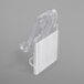 A clear plastic Snap Drape table skirt clip attached to a table.