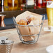 A small metal basket of pastries on a table.