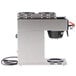 A silver Bunn automatic coffee brewer with black and red accents.