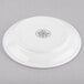 A white Libbey Porcelana double well porcelain saucer with black text.