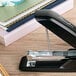 A black Swingline stapler on a table.