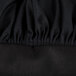 A close up of a black fabric chef hat with ruffles.