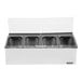 A stainless steel San Jamar condiment bar with four containers.