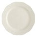 An Acopa ivory stoneware plate with a scalloped edge.
