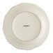 An ivory stoneware plate with black scalloped text that reads "Acopa"