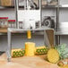 A Tellier pineapple corer and peeler on a table with a pineapple sliced up.