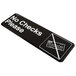 A black rectangular Vollrath No Checks Please sign with white text on a counter.