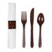 A pre-rolled white linen-like napkin with a decorative band, accompanied by a brown plastic fork, knife, and spoon.