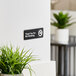 A black and white Vollrath Thank You For Not Smoking sign on a wall.