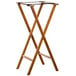 An American Metalcraft walnut wood tray stand with two legs and a black strap.