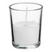 A clear glass candle with white wax inside.