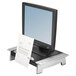 A Fellowes monitor riser with paper on it.