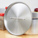 A silver Vollrath pot with a silver lid on top.
