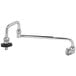 A T&S chrome wall mounted pot filler with a black handle.