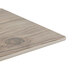 A Thunder Group Sequoia faux wood melamine serving board on a wood table.