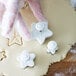 a person's hands in gloves cutting out cookies
