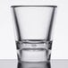 A clear SAN plastic shot glass with a clear glass on top.