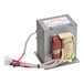 An Amana high voltage transformer with wires in a grey metal box.