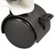 A black metal CPU stand with white and black casters.