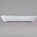 A white rectangular tray with a scalloped edge.