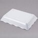 A white rectangular scalloped melamine tray.