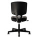 A close up of a black HON Volt leather office chair with wheels.