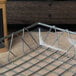 A Clipper Mill clear plastic basket liner on a metal tray in a bakery display.