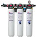 3 white water filters with red and black labels in a white container.