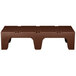 A brown plastic Cambro bow tie dunnage rack with a solid top.
