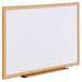 A Universal white melamine dry-erase board with a wooden frame.