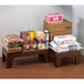 A brown Cambro dunnage rack holding boxes of food on a table.