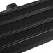 A black rectangular tray rail with four rows of black bars on a table.