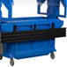 A black metal bar with blue plastic tray rails on a table.