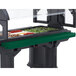 A green Cambro tray rail on a buffet table.