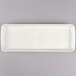 A white rectangular Tuxton china tray with a gray border.