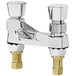 A close-up of a T&S Deck Mounted Metering Faucet with two handles.