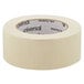 A roll of Universal beige masking tape with black text on the label.