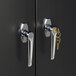 The metal door handles on a HON Brigade storage cabinet with keys in the locks.