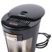A black and silver Bunn My Cafe single cup coffee maker on a counter.