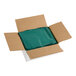 A green plastic bag in a cardboard box with white text.