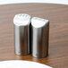 A Tablecraft Marina stainless steel salt and pepper shaker set on a table.