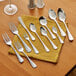 An Acopa Edgewood stainless steel oyster fork on a yellow napkin.