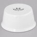 A white Tuxton porcelain ramekin with black text.