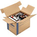 A Banker's Box SmoothMove Prime small moving box filled with a variety of objects.