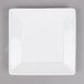 A Tuxton white square china plate with a white rim.