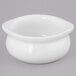 A Tuxton white porcelain onion soup crock on a gray surface.