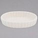 A white oval dish with a scalloped edge.