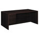 A dark wood HON pedestal desk.