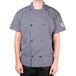 A man wearing a Chef Revival gray short sleeve chef jacket with mesh back.